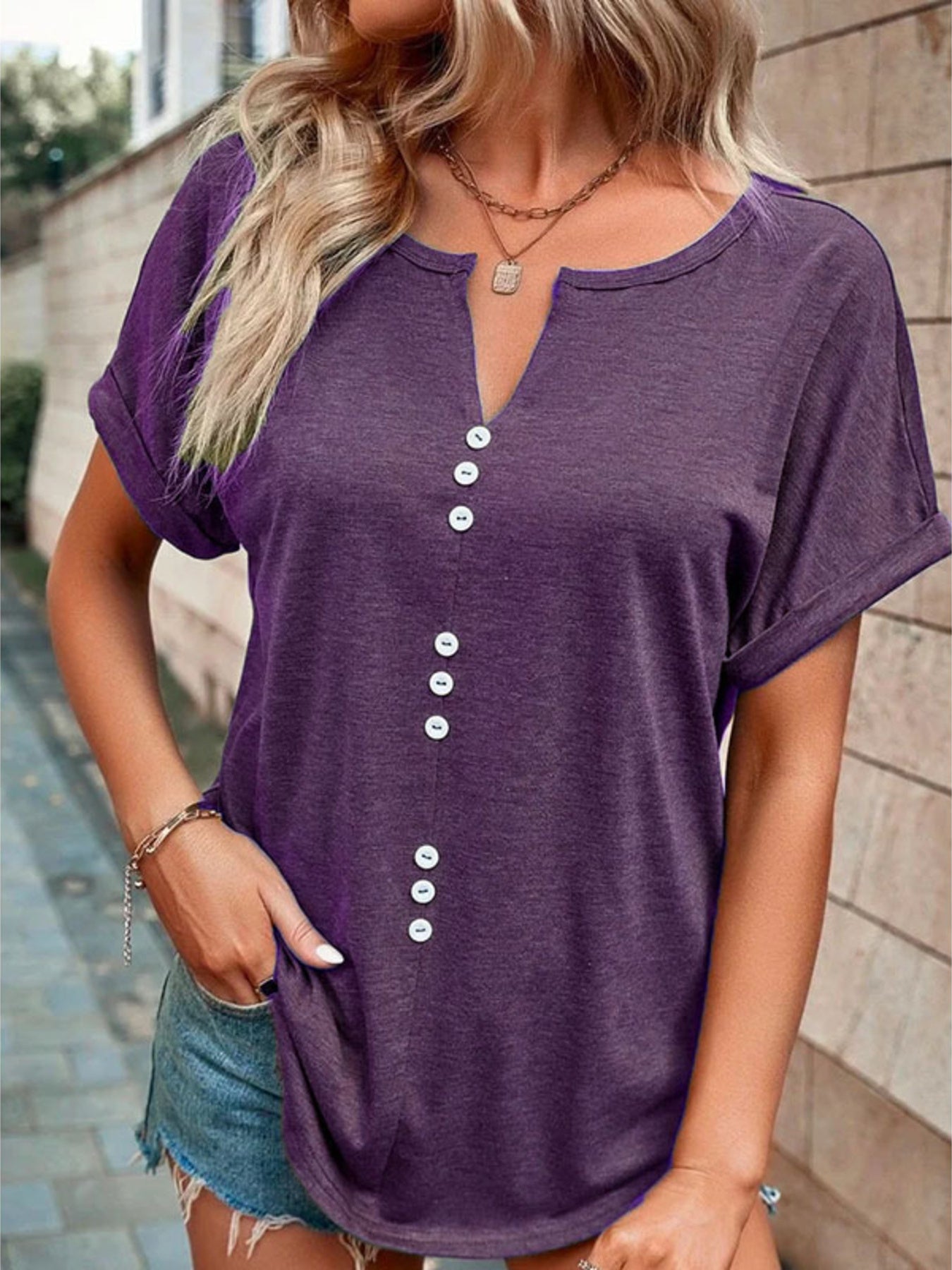 Purple short sleeve t-shirt with V-neck and decorative buttons