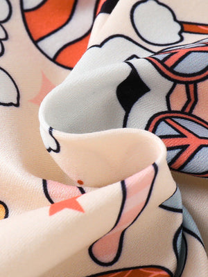 Baby one-piece with playful holiday print, featuring candy canes and disco balls on a cream background.