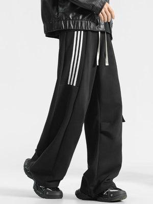 Men's black loose-fit sweatpants with white side stripes and drawstring