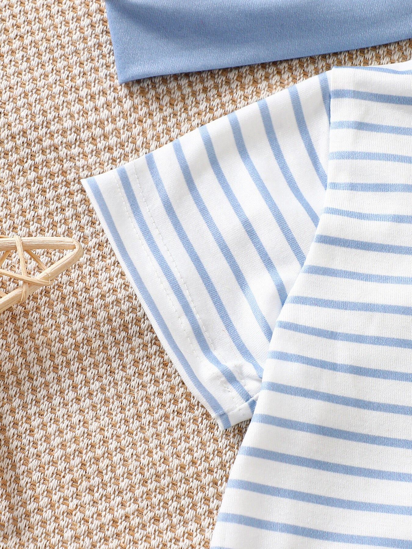 Baby bodysuit set with blue and white stripes and a solid blue top.