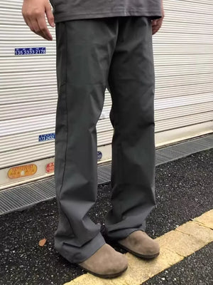 Men's dark gray sweatpants with a relaxed fit, styled with casual shoes.