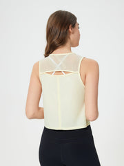 Pastel Yellow cropped active tank with mesh back detail and white bra straps visible.