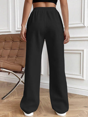 Black pleated palazzo trousers with drawstring waist and wide legs.