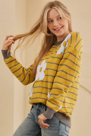 Yellow intarsia knit sweater with daisy pattern and grey stripes.