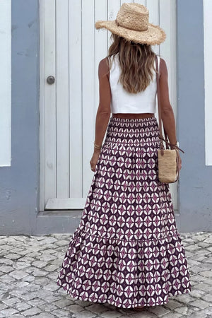 Maxi skirt with geometric print, smocked waist, and tiered ruffle hem.