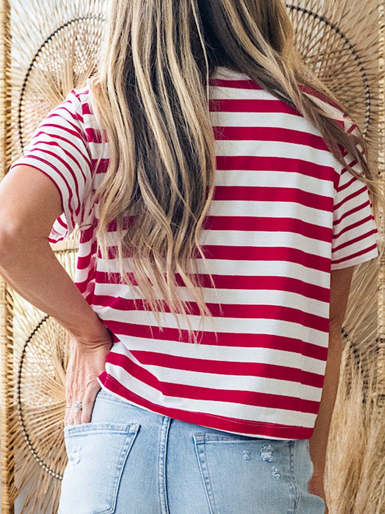 Red and white striped cotton blend t-shirt with a round neck and short sleeves.