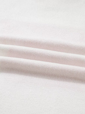 White knit sweater with a textured fabric detail