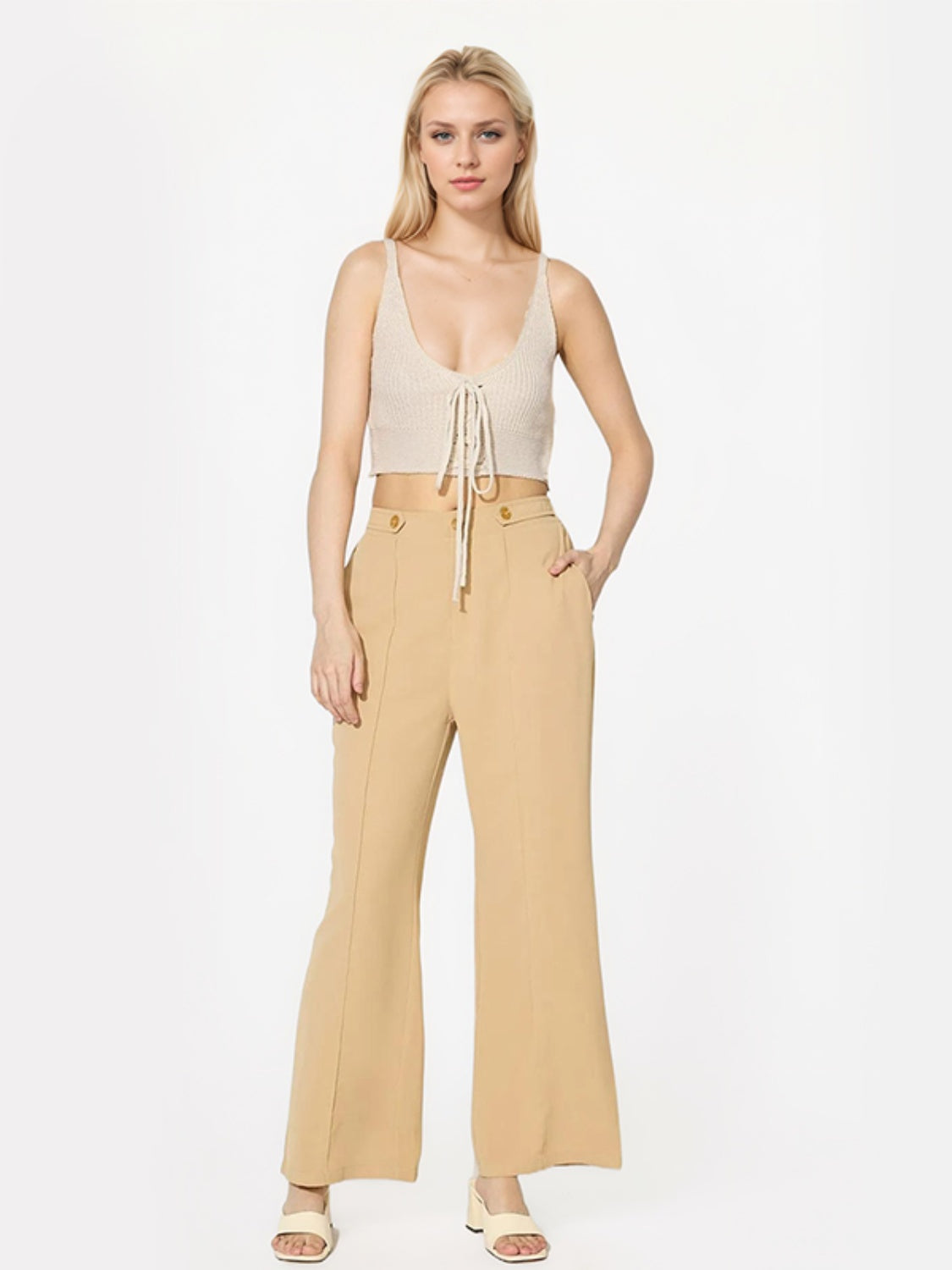 Tan tailored seam front wide leg trousers with button detail.
