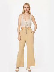 Tan tailored seam front wide leg trousers with button detail.