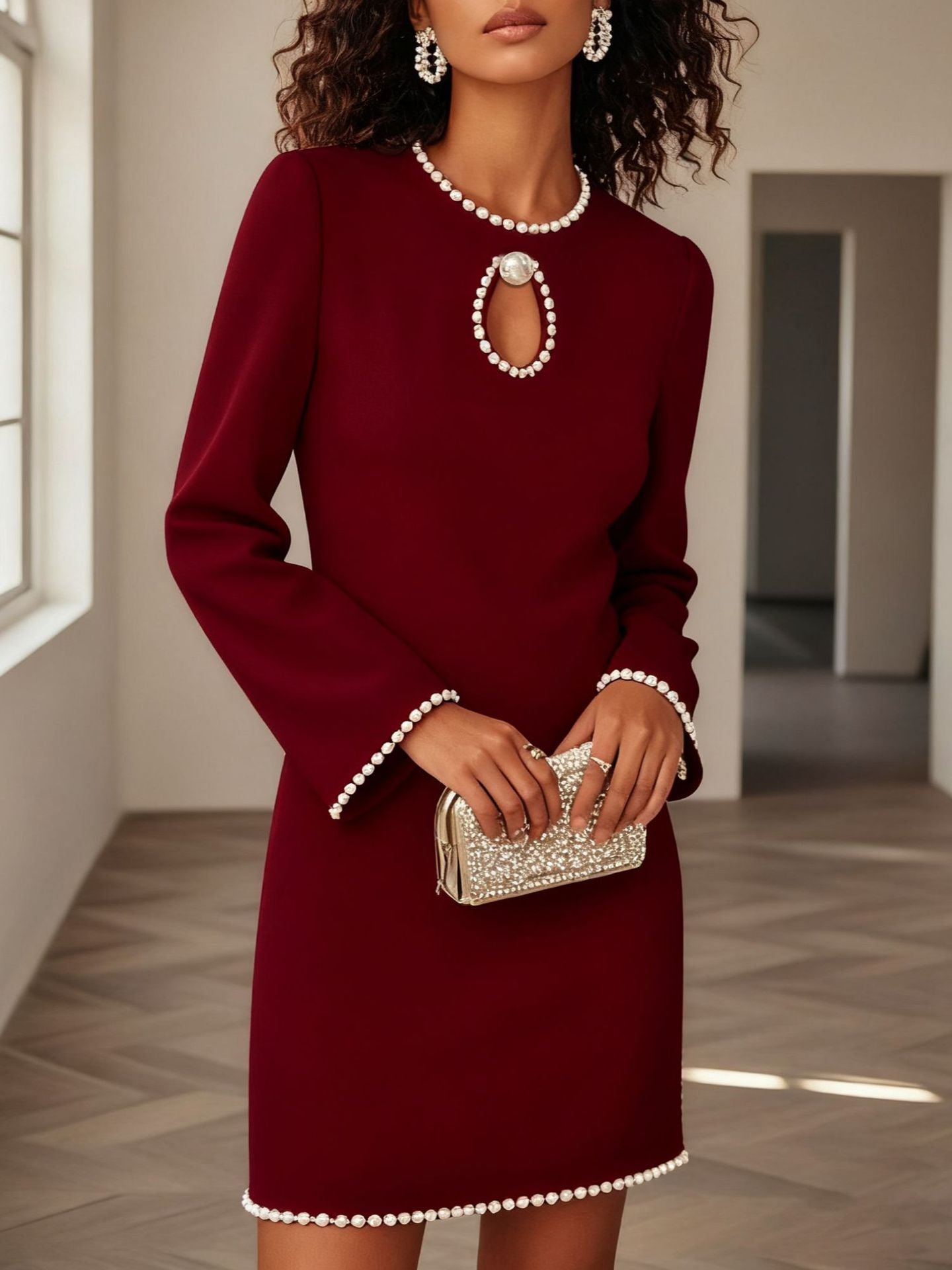 Wine red mini dress with pearl trim, keyhole neckline, and bell sleeves.