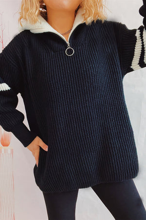 Black ribbed knit quarter-zip sweater with white stripe sleeves and collar.