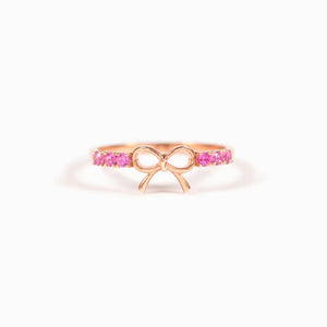 Rose gold ring with a bow design and pink gemstones
