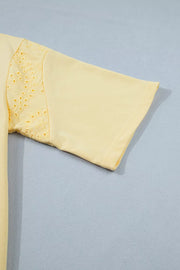 Yellow cotton half-sleeve top with eyelet lace detail on the sleeve.