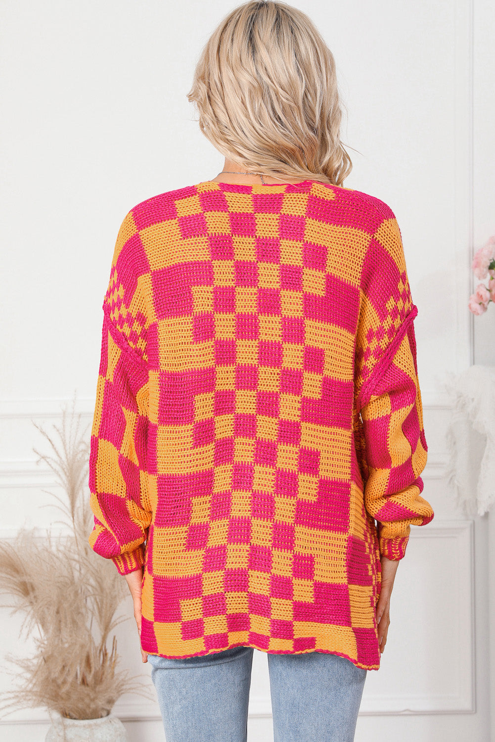 Checkerboard knit open cardigan in orange and pink acrylic with a relaxed fit.