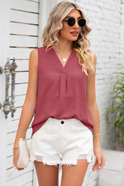 Burgundy sleeveless blouse with V-neck and pleated front detail.