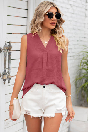Burgundy sleeveless blouse with V-neck and pleated front detail.