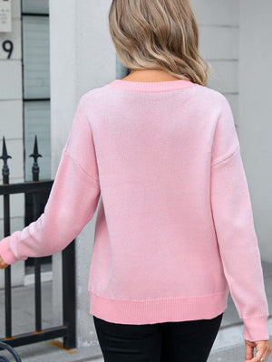 Blush pink knit sweater with crew neck and long sleeves.