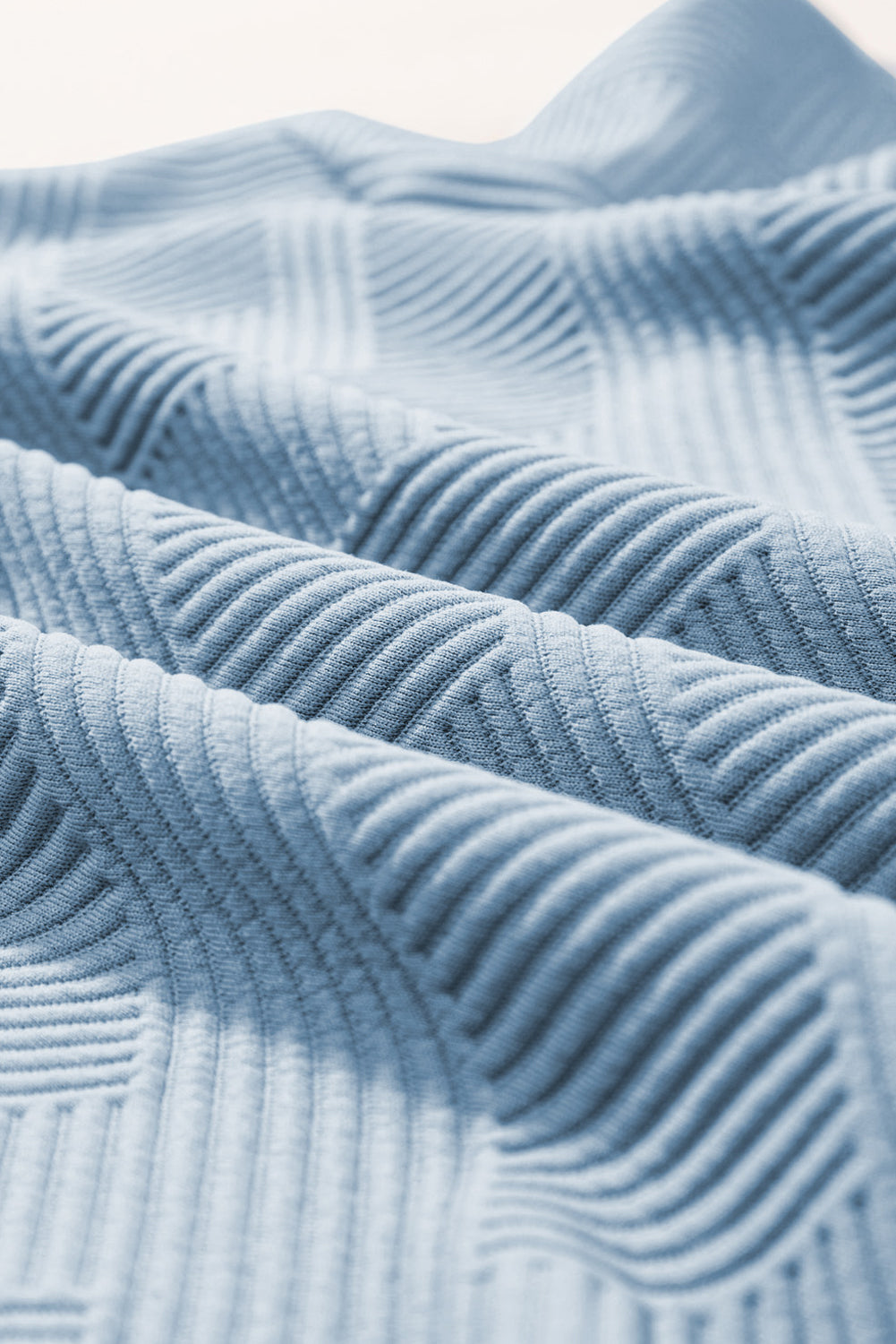 Light blue textured knit culottes with a subtle geometric pattern detail.