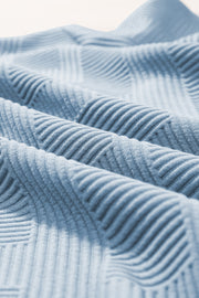 Light blue textured knit culottes with a subtle geometric pattern detail.