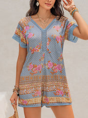 Light blue floral embroidered romper with V-neck and short sleeves