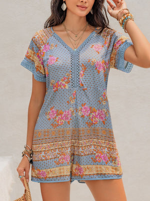 Light blue floral embroidered romper with V-neck and short sleeves