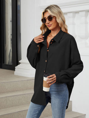 Black oversized corduroy shirt jacket with button front and collar, styled casually.