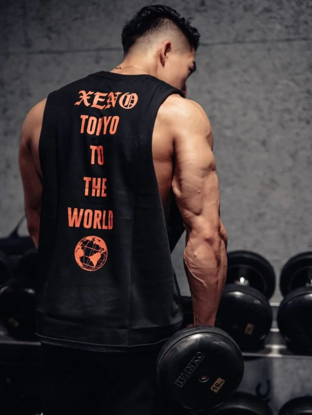 Black graphic muscle tank with orange Xeno Tokyo print and globe graphic.