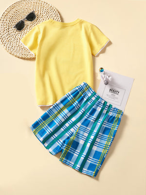 Toddler yellow cotton graphic tee with white trim and blue plaid shorts.