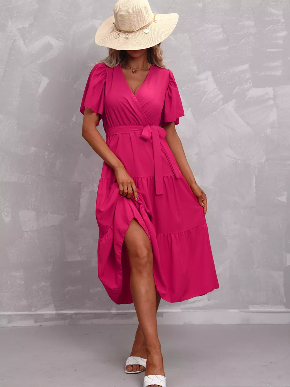 Hot Pink tiered midi dress with flutter sleeves, V-neck, and belted waist.