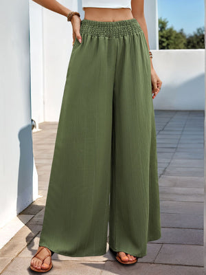 Moss green textured palazzo trousers with elastic waist and wide legs.
