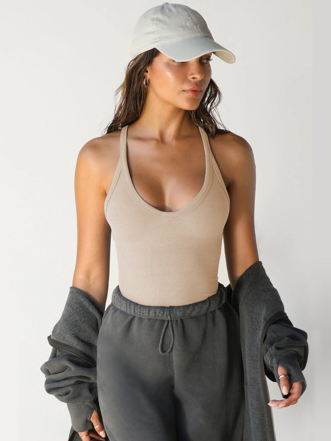 Tan ribbed racerback tank top with deep scoop neckline.