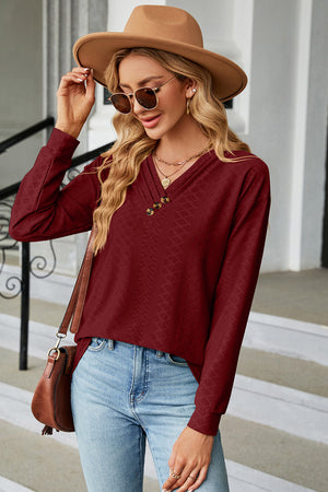 Burgundy textured henley v-neck top with button detail and long sleeves