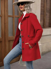 Scarlet button-up trench coat with cinched waist and gold buttons, worn with jeans.