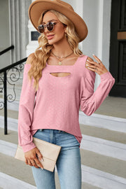 Blush pink textured open shoulder blouse with keyhole neckline and long sleeves.