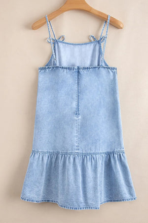 Light blue denim sundress with tie straps, square neckline, ruffled hem, and smocked back detail.