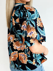 Black floral print bubble sleeve blouse with button detail.