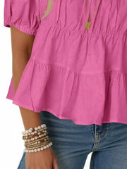 Rose pink maternity blouse with puff sleeves, tiered ruffles, and smocked bodice detail.