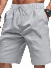 Light gray chino shorts with drawstring waist and pockets, styled casually.