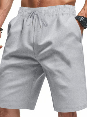 Light gray chino shorts with drawstring waist and pockets, styled casually.
