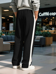 Black sweatpants for men with white contrast stripe detail and drawstring waist.