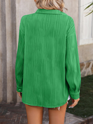 Green textured pleat oversized button-down shirt with long sleeves.