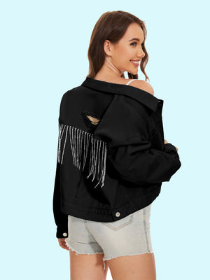 Black distressed denim trucker jacket with crystal fringe detail and ripped accents.