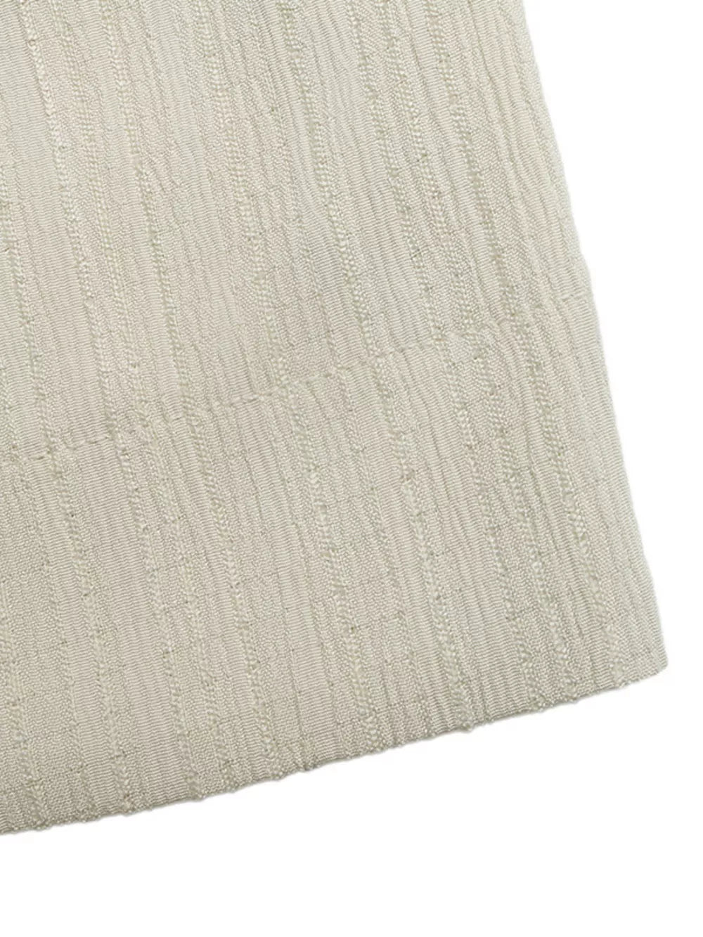 Cream textured fabric romper detail with vertical ribbed pattern