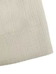 Cream textured fabric romper detail with vertical ribbed pattern