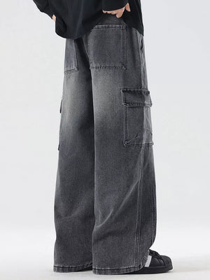 Oversized dark gray denim cargo jeans with drawstring waist and multiple pockets.