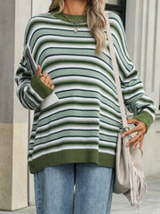 Oversized knit sweater with green, white, and dark green stripes, crew neck, and ribbed cuffs.