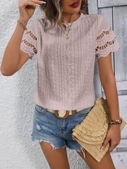 Pink scalloped eyelet blouse with short sleeves and intricate allover pattern.