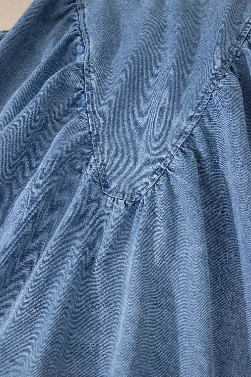 V-shaped pleated denim sleeveless top with a V-neckline detail