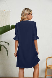 Navy V-neck shift dress with flutter sleeves and a casual hem.
