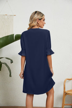 Navy V-neck shift dress with flutter sleeves and a casual hem.